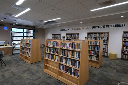 book stacks with a large roll-up door in the background